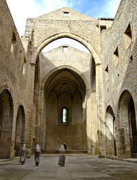 People walking in old building