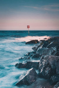 Scenic view of sea against sky moving sea over rocks 