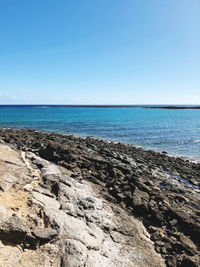 Scenic view of sea against clear blue sky