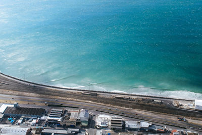 High angle view of buildings by sea