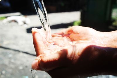Close-up of water falling on cupped hands
