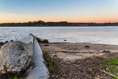 Scenic view of lake against sky at sunset