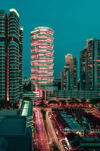 Aerial view of illuminated city buildings against sky