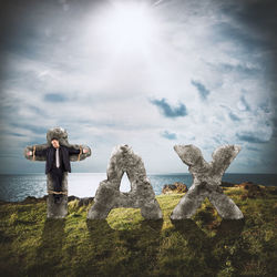 Man standing on land against sky