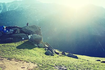 Man standing on cliff against sky
