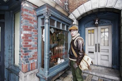 Portrait of mid adult man standing against building in city