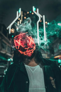 Close-up of man wearing mask standing outdoors