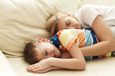 Young woman lying on bed at home