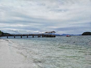 View of beach against cloudy sky