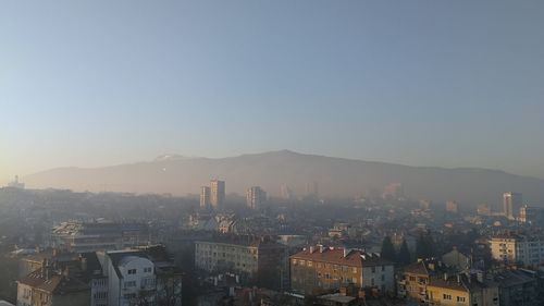 High angle view of buildings in city against clear sky