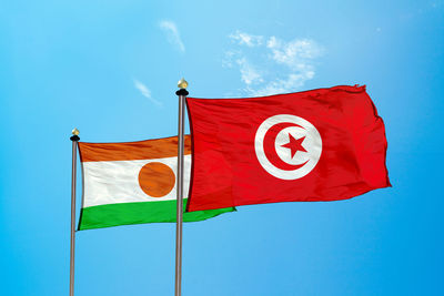 Flags against blue sky