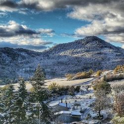 Scenic view of snow covered mountains against sky