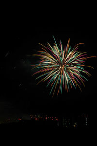 Low angle view of firework display at night