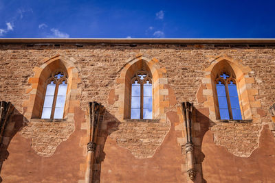 Low angle view of historical building against blue sky