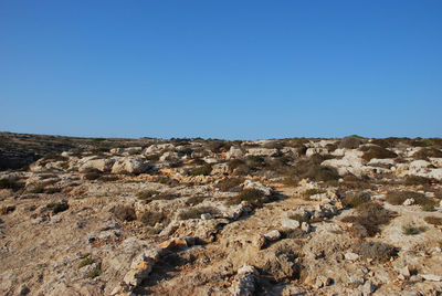 Scenic view of rocky mountains against clear blue sky