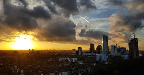 View of cityscape against cloudy sky