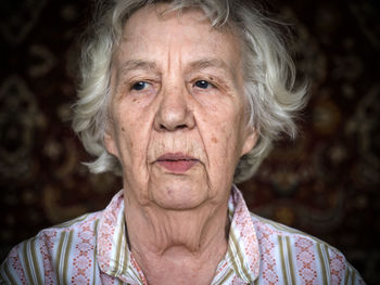 Close-up portrait of senior woman at home