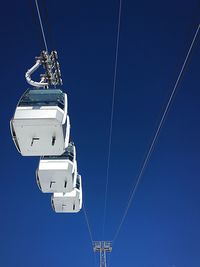 Low angle view of ship against clear blue sky