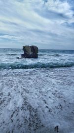 Scenic view of sea against cloudy sky