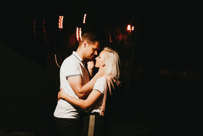 Couple embracing in darkroom