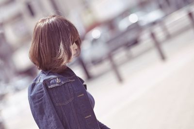 Rear view of girl standing on floor