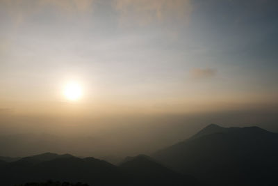 Scenic view of silhouette mountains against sky during sunset