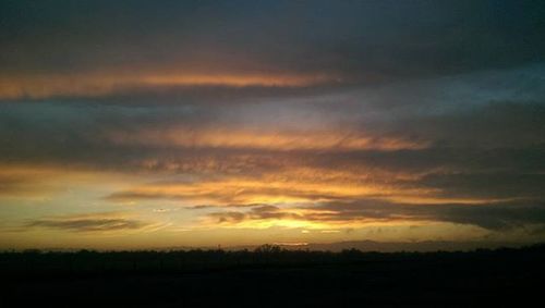 Scenic view of landscape against sky at sunset