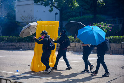 People with umbrella on wet street