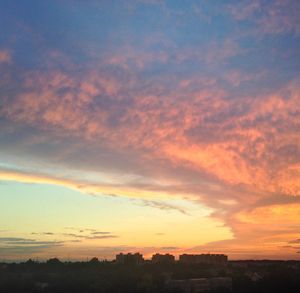 Silhouette landscape against dramatic sky during sunset