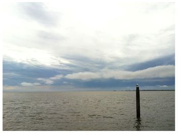 Scenic view of sea against cloudy sky