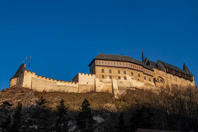 Low angle view of historic building against blue sky