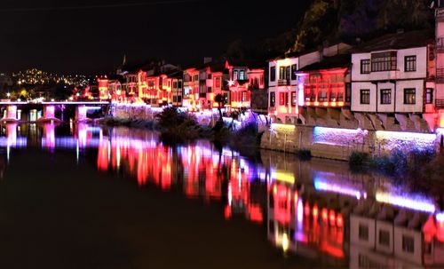 Reflection of illuminated buildings in lake at night