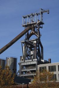 Low angle view of crane against sky