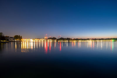 Scenic view of lake against clear sky at night