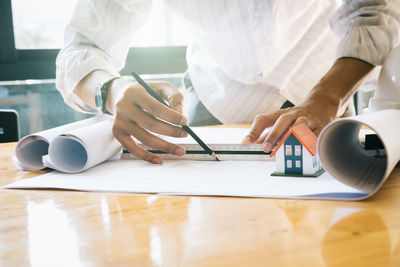 Midsection of man working at table