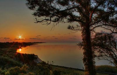 Scenic view of calm sea at sunset