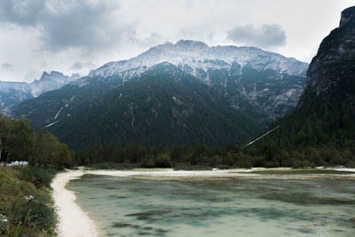 Scenic view of sea and mountains against sky