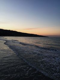 Scenic view of sea against clear sky during sunset