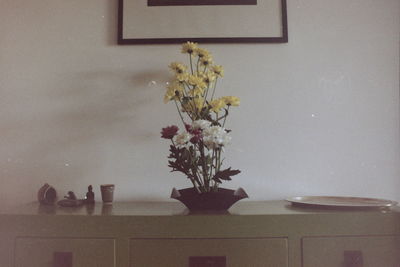 Flower vase on table at home
