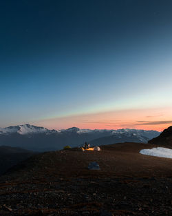 Scenic view of snowcapped mountains against sky during sunset