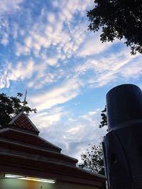 Low angle view of building against cloudy sky