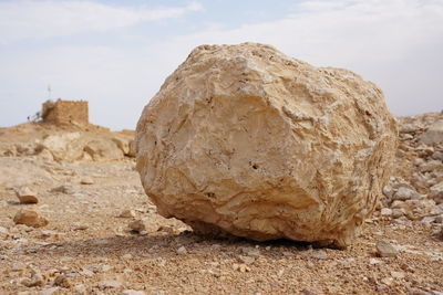 Close-up of rock formation on land against sky
