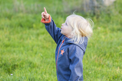 Side view of girl standing on field