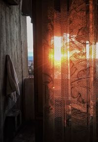 Close-up of curtain against sky during sunset
