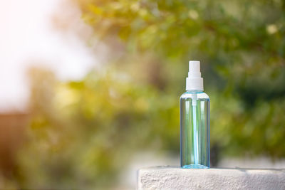 Close-up of bottle against stone wall