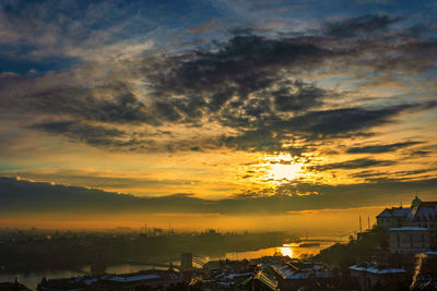 High angle shot of townscape against orange sky