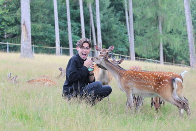 Surprised men feeds deer