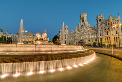 The plaza de cibeles with the palace of communication and the cibeles fountain in madrid at night