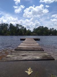 Pier over lake against sky