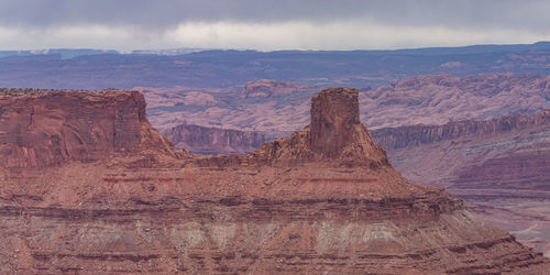 Rugged red sandstone rock formations tower above the eroded landscape